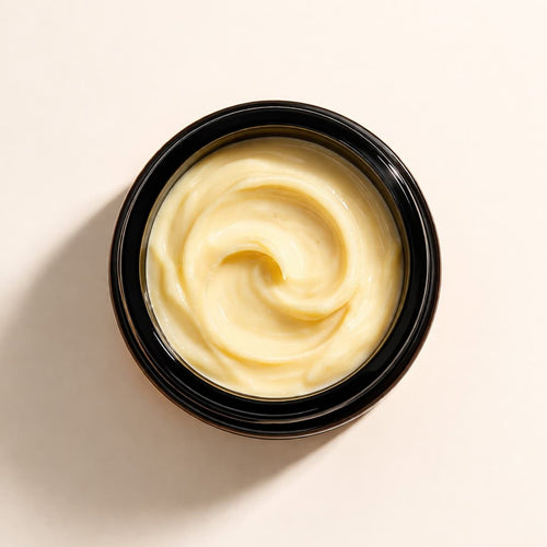 Black container with rich turmeric shea butter moisturiser texture, absorbs without greasiness
