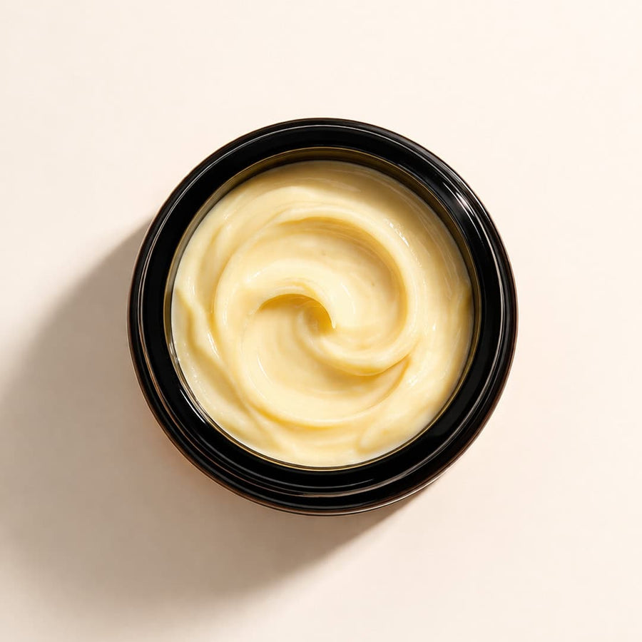 Black container with rich turmeric shea butter moisturiser texture, absorbs without greasiness