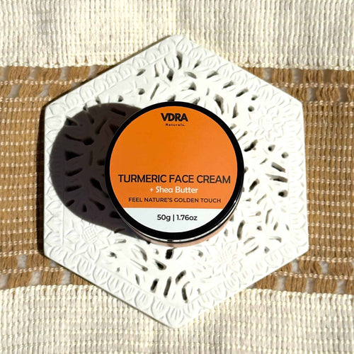 Jar of VDRA Naturals Turmeric Face Cream on a textured background