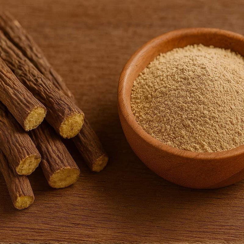 Wooden bowl filled with a brown  licorice root powder next to dried roots on a wooden surface