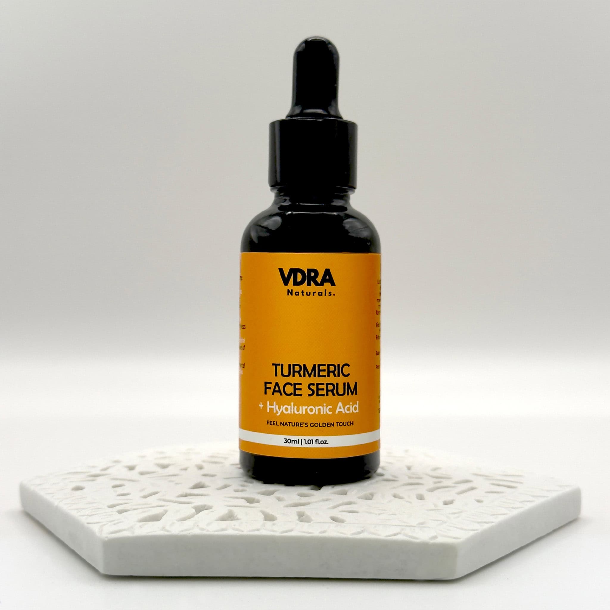 VDRA Naturals Turmeric Face Serum bottle with dropper on a white background