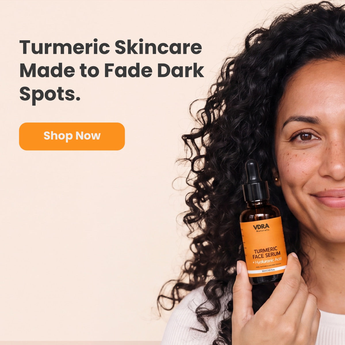 Woman holding a bottle of VDRA Naturals Turmeric Face Serum with hyaluronic acid — turmeric skincare made to fade dark spots, shop now.